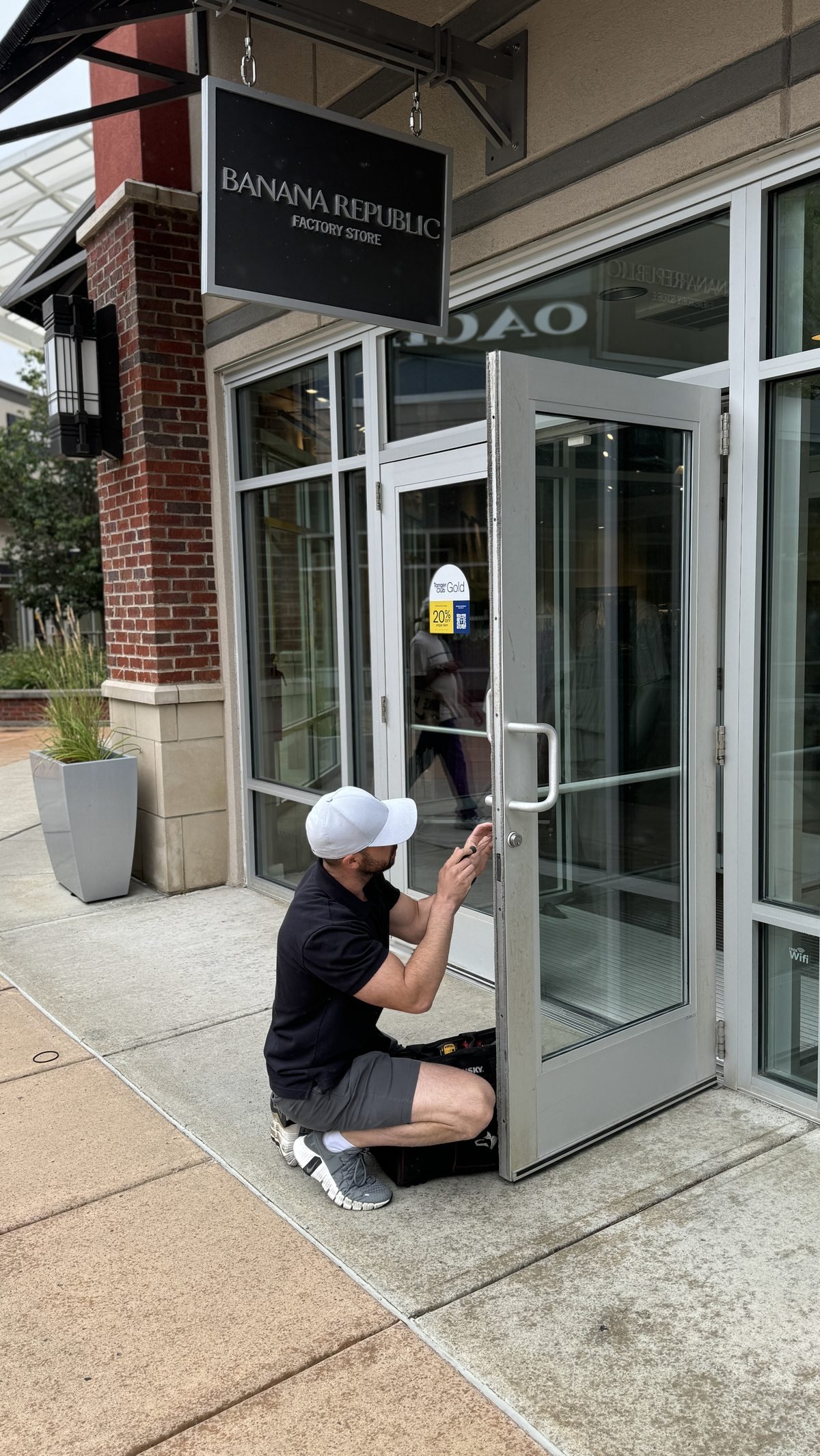 Locksmith Powell Ohio technician servicing a commercial storefront glass door lock at a retail location in Powell Ohio