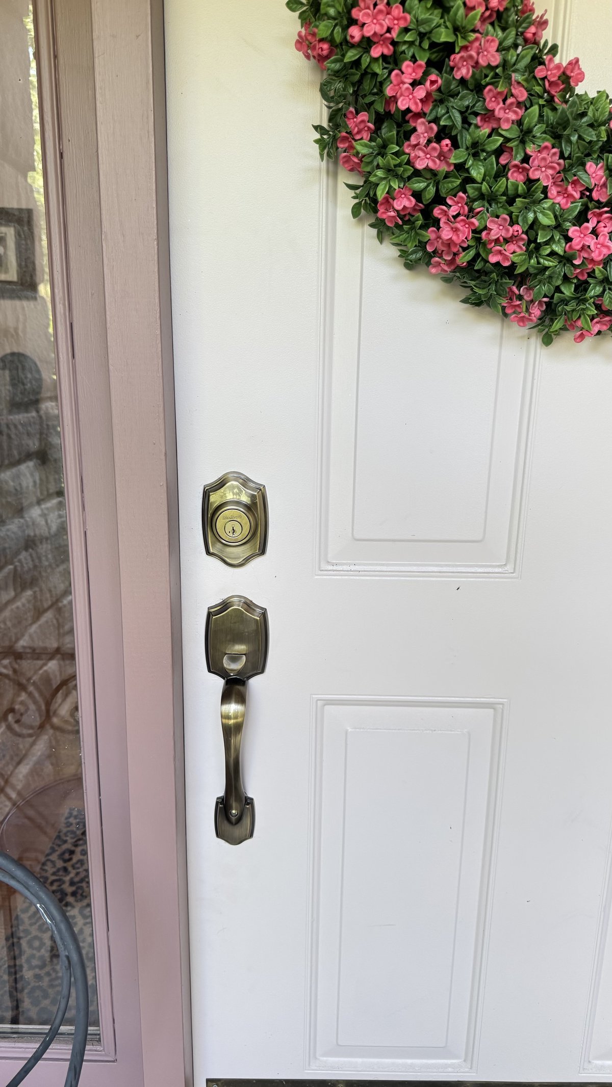 New antique brass deadbolt and door handle set installed on white residential front door by Locksmith Powell Ohio