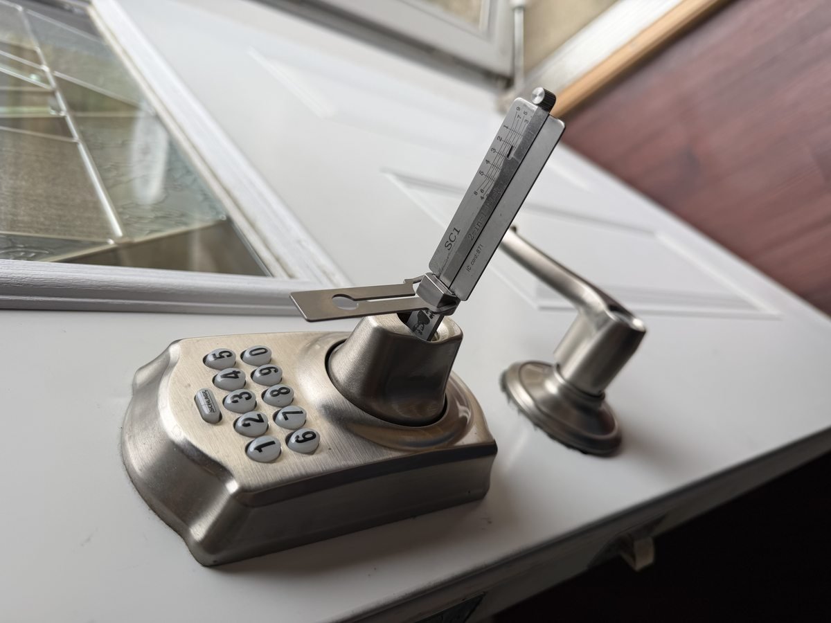 Locksmith Powell Ohio opening a Schlage residential keypad lock using professional pick tools in Powell Ohio