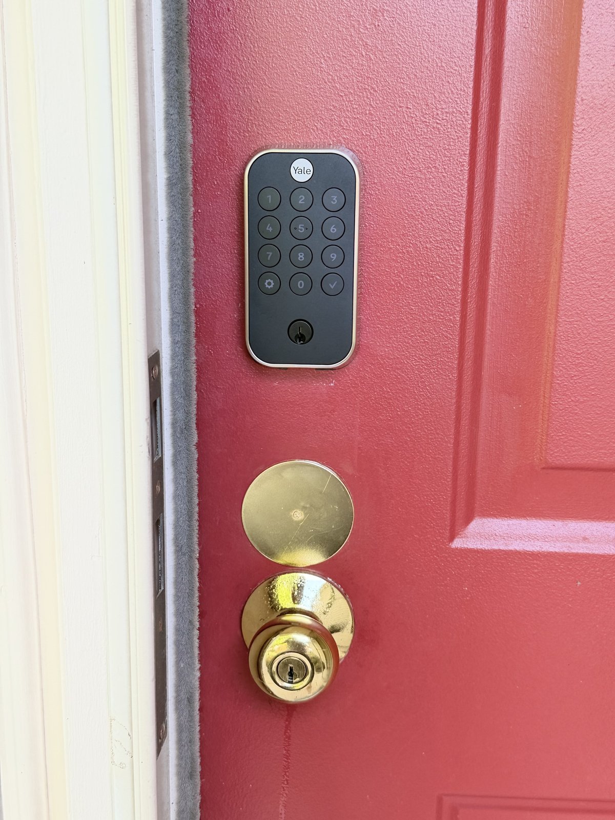 Yale keypad lock professionally installed on red residential front door in Delaware Ohio — smart lock and keypad installation by Locksmith Powell Ohio